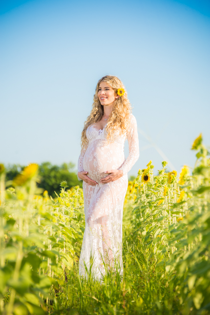 Maternity picture in field of sunflowers