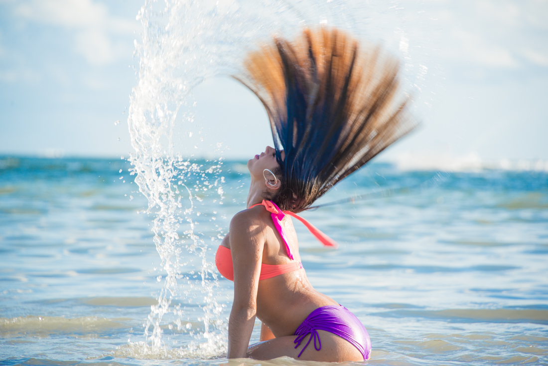 Quinceañera whipping her hair out of the water at beach
