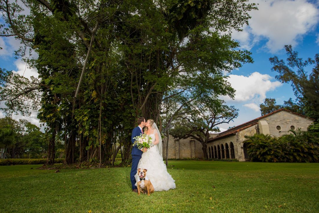 Bride and groom with their dog.